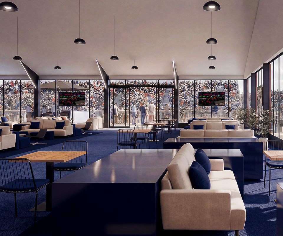 Ignition Club &mdash; lounge com sof&aacute;s e telas exibindo a corrida