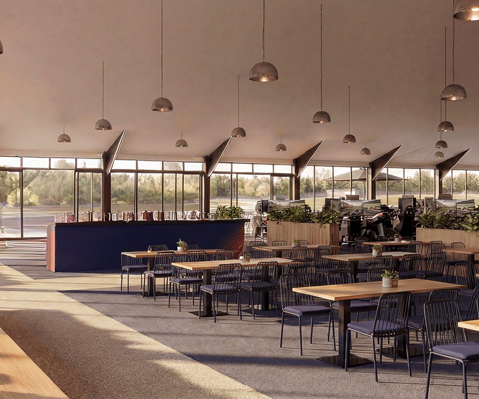 Ignition Club &mdash; sal&atilde;o de restaurante com p&eacute;-direito alto e vista para a pista